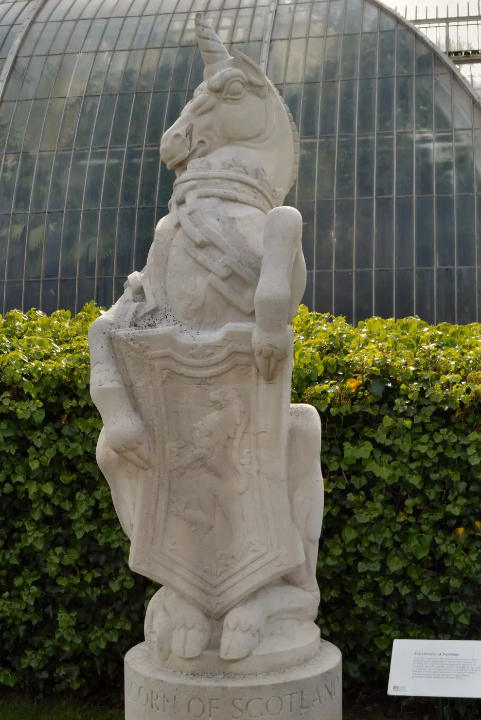 Stone statue of a unicorn holding a shield