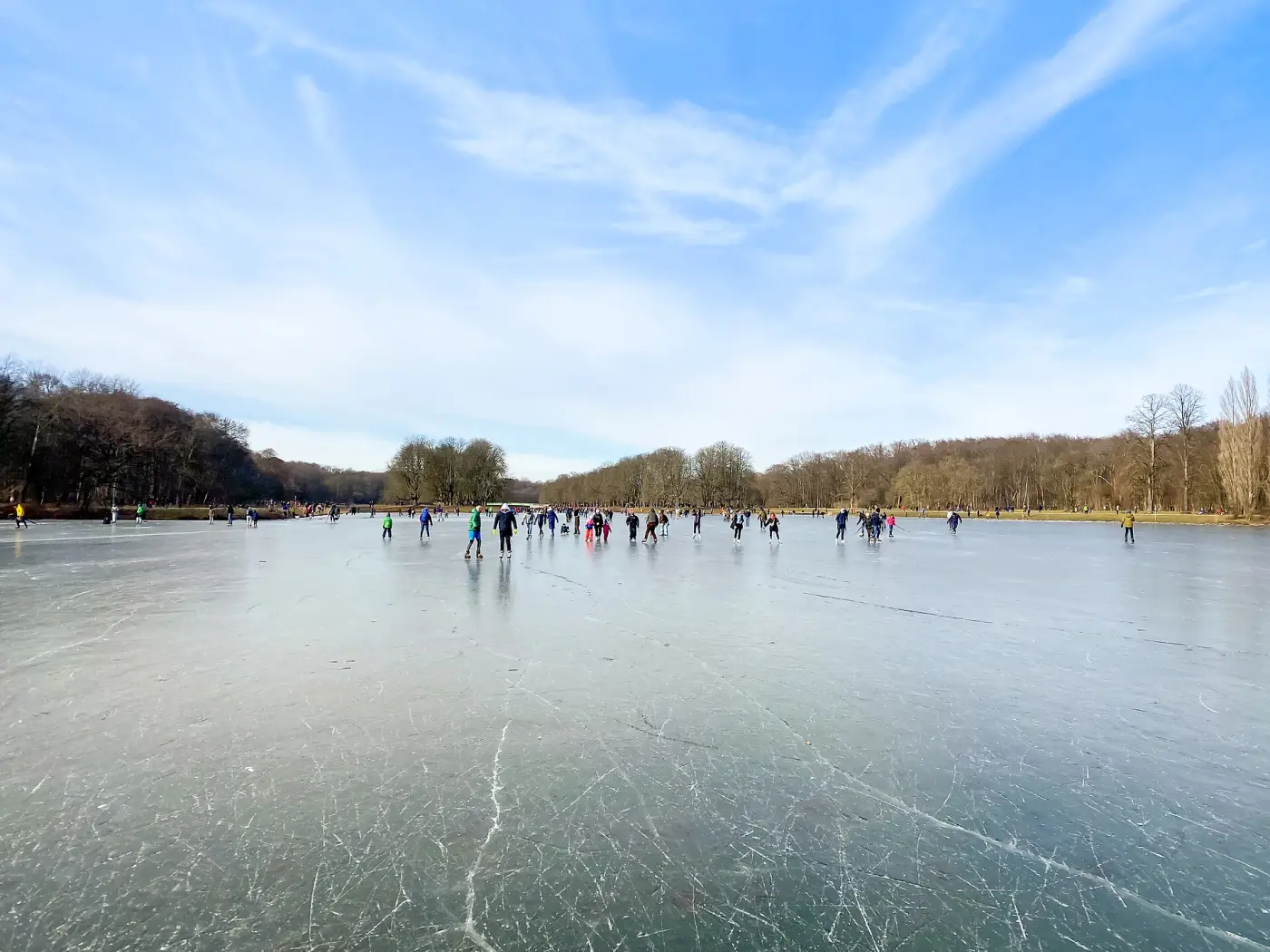 Ice skaters on the frozen Decksteiner Weiher lake in Cologne