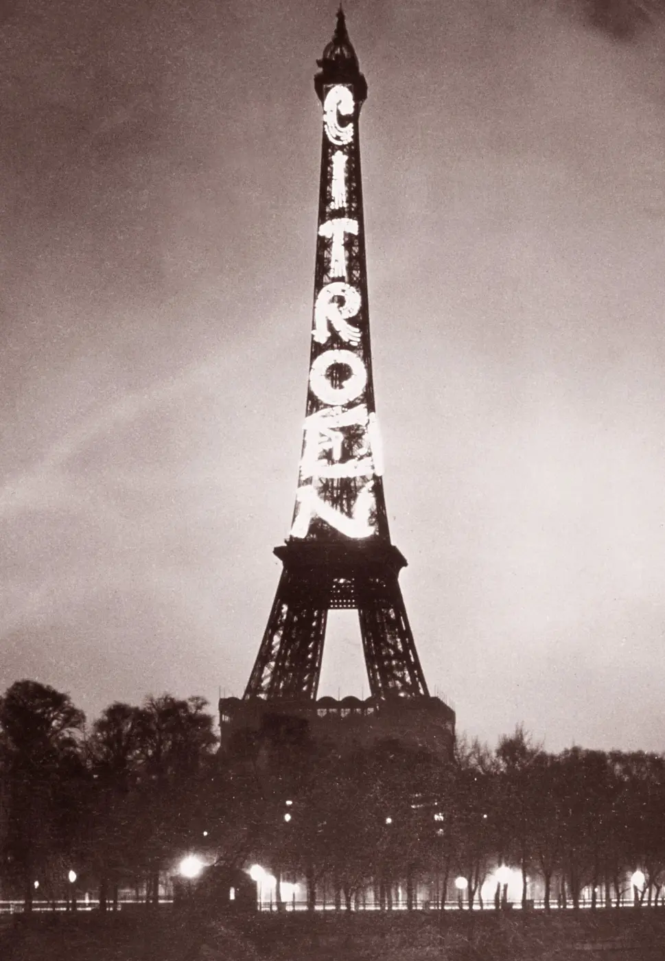 The Eiffel Tower at night, with the word CITROËN glowing vertically in huge letters along its side