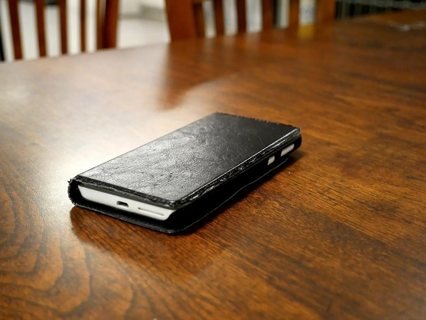 A smartphone in a case lying on a table