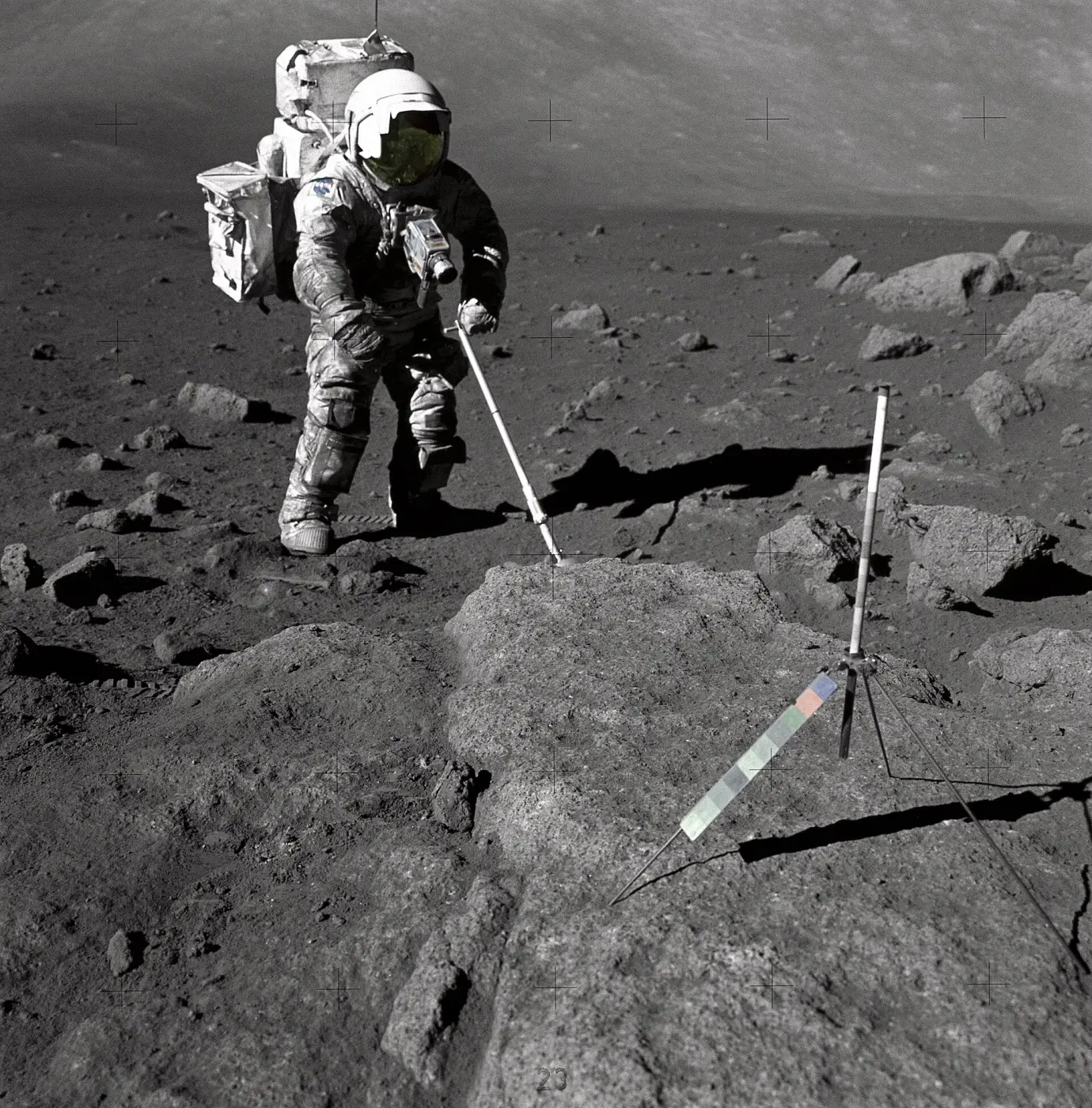 Astronaut Jack Schmitt in his spacesuit on the Moon, suit and legs smeared grey with moondust