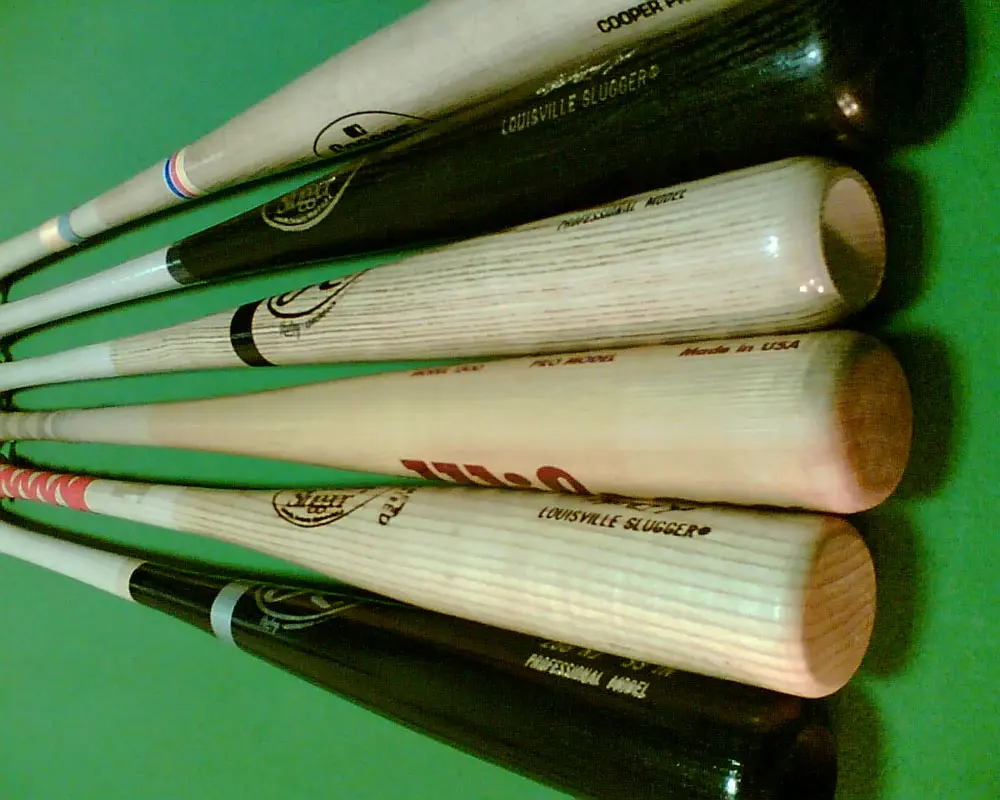 Several wooden baseball bats side by side