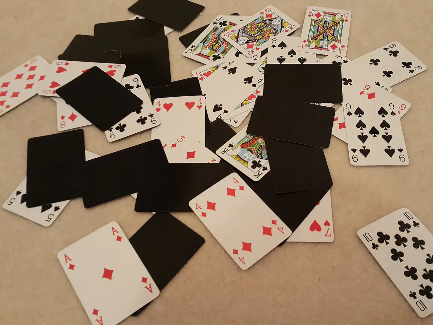 Playing cards scattered on a carpet